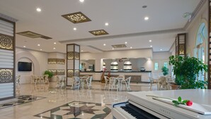 A spacious lobby with a grand piano, modern furniture, and decorative elements. - Club Paradiso Hotel  (Alanya)