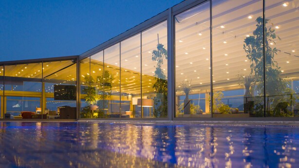 A modern building with large glass windows and a pool area. - Spektr Boutique Hotel Yalıkavak (Bodrum)