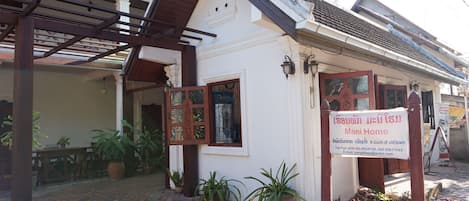 A traditional house with a signboard advertising 'Mani Home'.