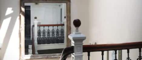 A staircase with a white balustrade and a skylight above.