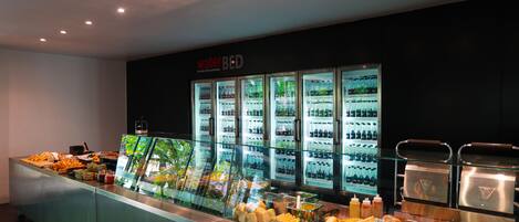 A buffet area with a waterbed sign, various food items, and a refrigerated display case.