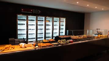 A buffet area with a variety of food options and a refrigerated display case labeled "waterBED" with beverages.