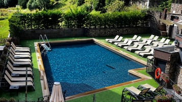 Seasonal outdoor pool, open 10:30 AM to 6:00 PM, pool umbrellas