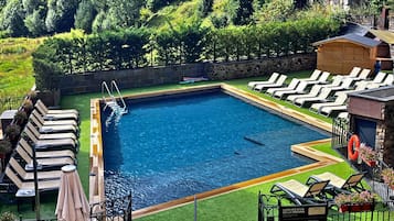 Seasonal outdoor pool, open 10:30 AM to 6:00 PM, pool umbrellas