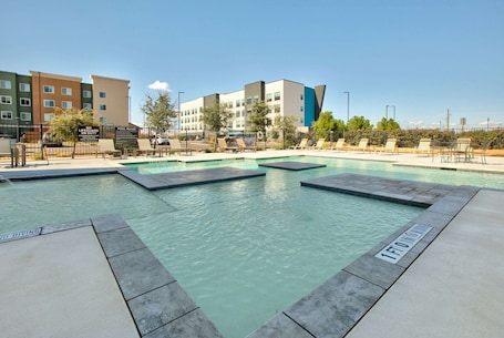 Seasonal outdoor pool. La Quinta Inn & Suites by Wyndham Lubbock Southwest