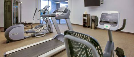 A fitness center with treadmills, a stair climber, and a weight machine.