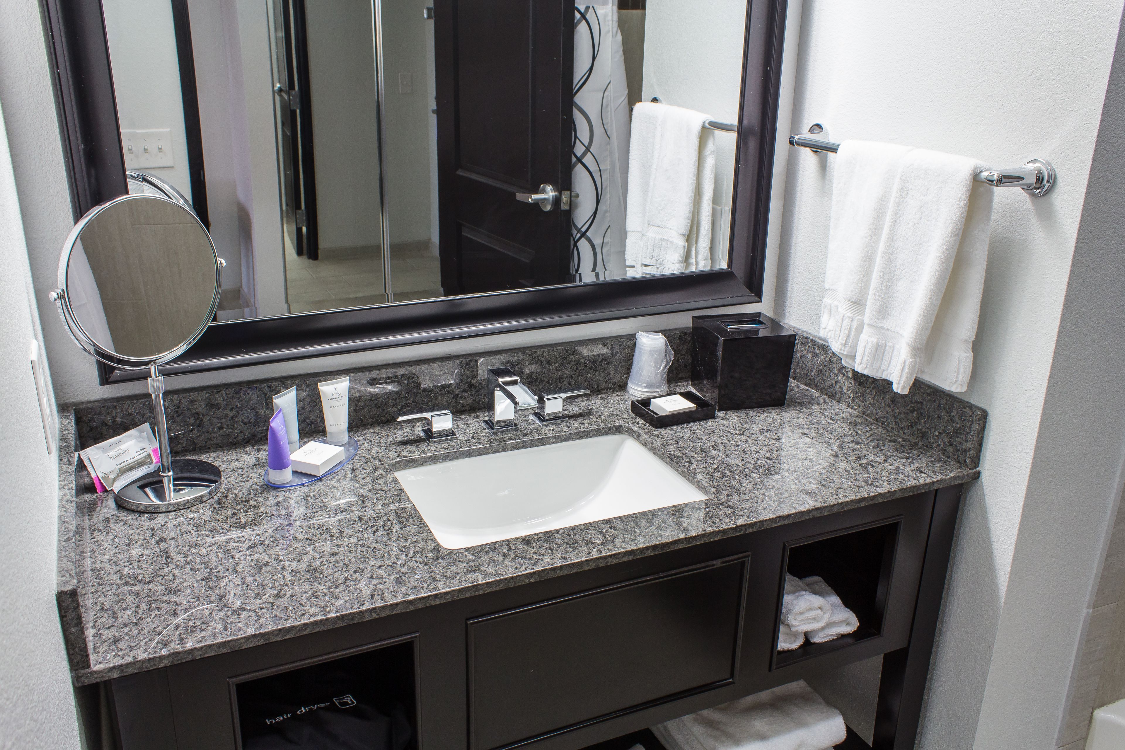 designer toiletries, hair dryer, towels