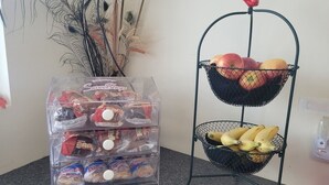 A kitchen counter with a bread dispenser and a fruit basket. - The Falls Motel - 2 Mi to " Watkins Glen State Park, Seneca Lake " AND 4 Mi to Watkins Glen International Track " The Glen " (Montour Falls)