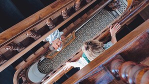 A view of a grand staircase with ornate wooden balusters and a patterned floor. - Le Manoir Hotel, BW Signature Collection (La Rochelle)