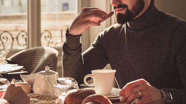 A person sitting at a table with a teapot, cups, and pastries. - Le Manoir Hotel, BW Signature Collection (La Rochelle)
