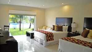 A hotel room with two beds, a large window with a view of a pool, and a desk with a chair.