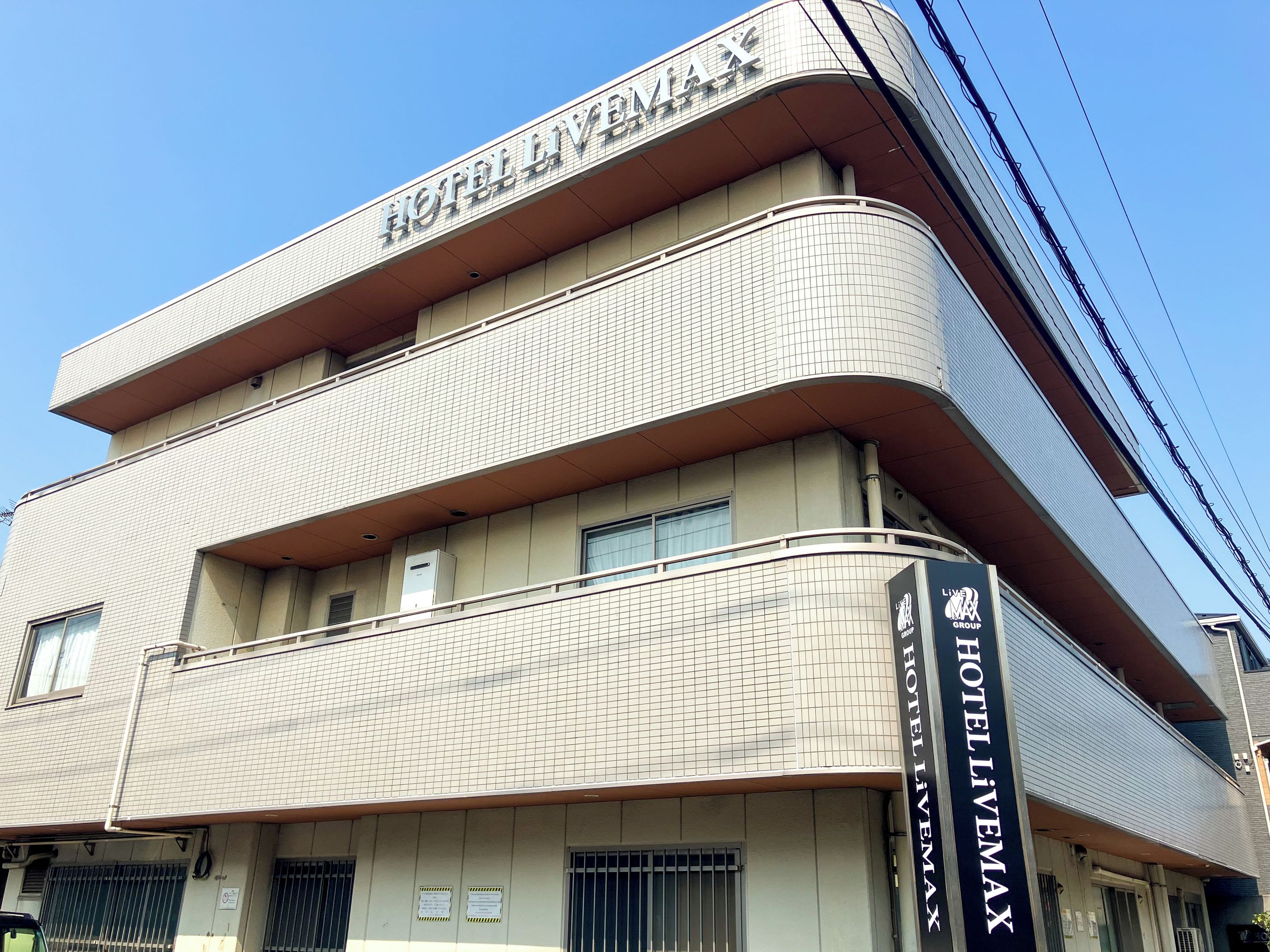 A multi-story hotel building with a tiled facade and a prominent sign reading 'HOTEL LITEMAX.'