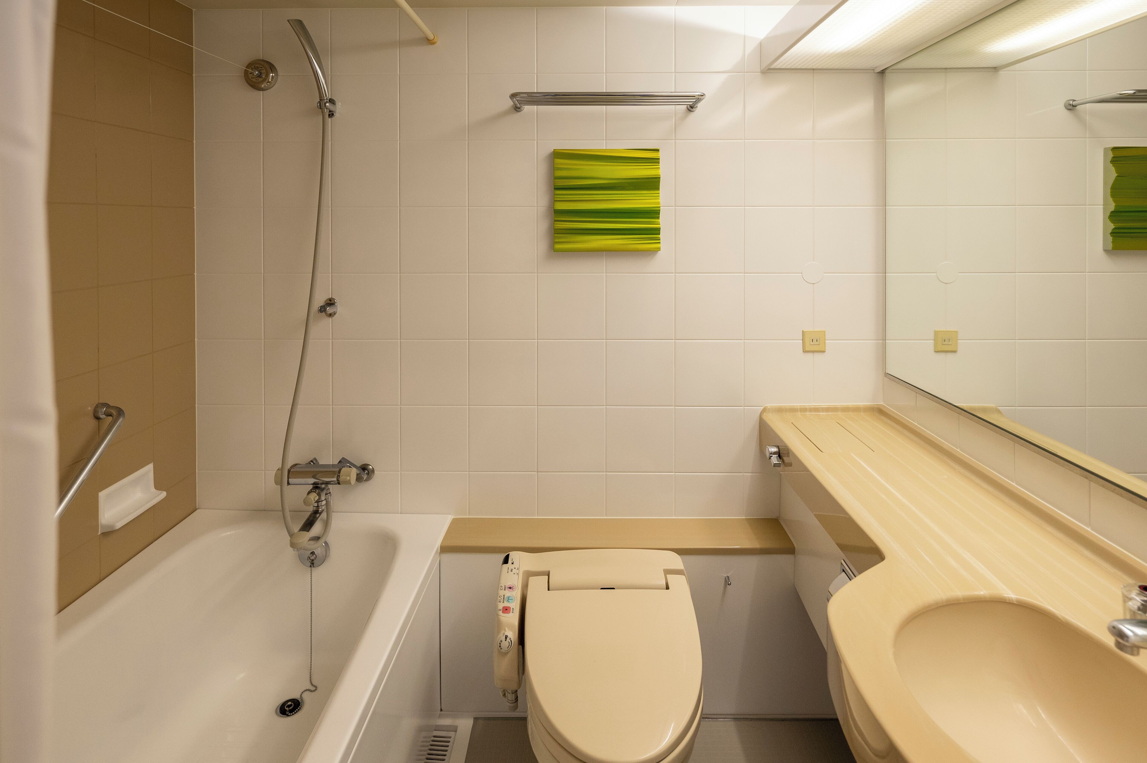 A bathroom with a bathtub, toilet, and sink.