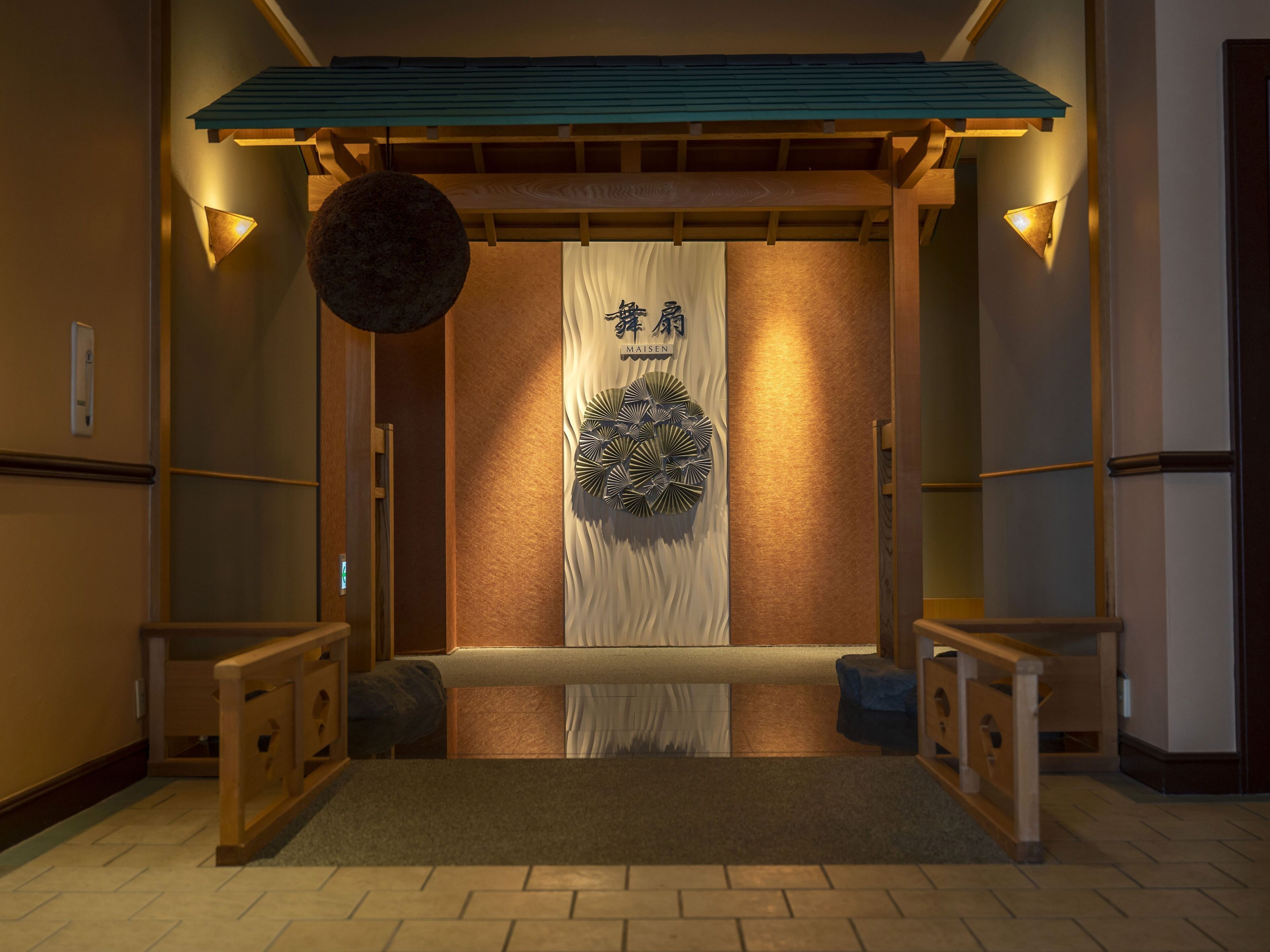 A traditional Japanese interior with tatami flooring, a shoji screen, and a hanging lantern.