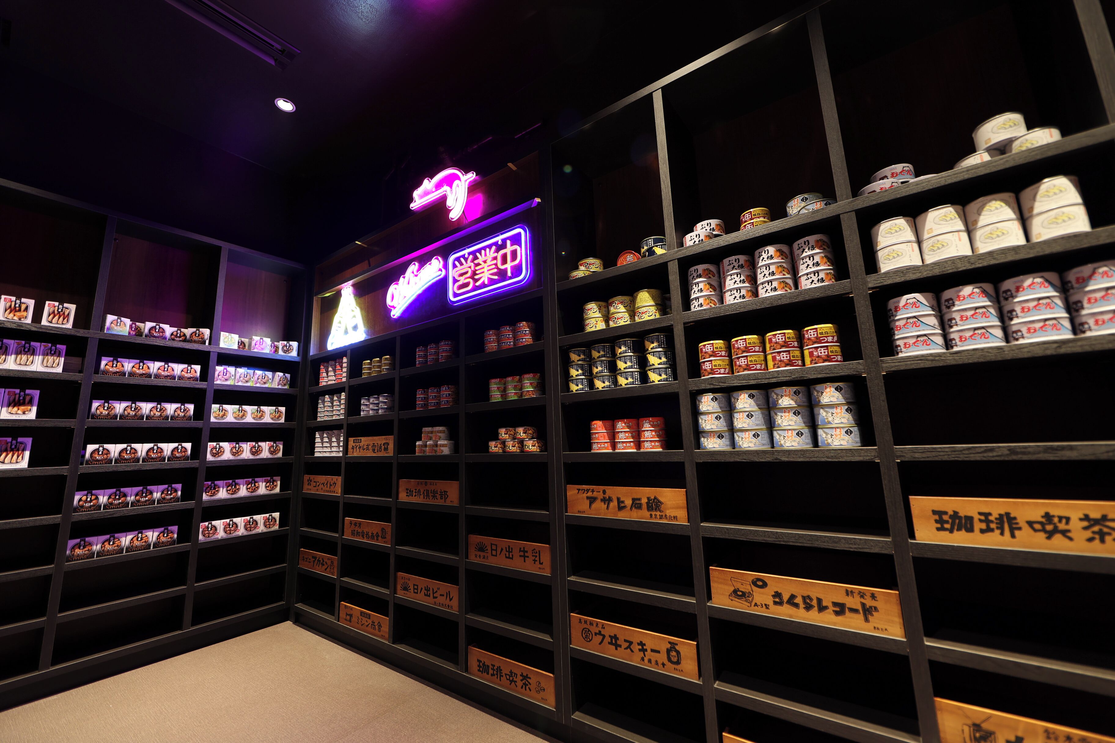 Un magasin avec des étagères remplies de conserves et des panneaux affichant du texte en japonais.