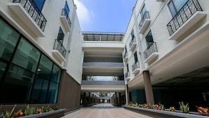 A multi-level building with a central atrium, balconies, and a patterned floor. - Temasek Hotel (Malacca City)