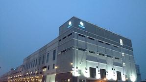 A modern hotel building with a flat facade, multiple windows, and illuminated signage. - Temasek Hotel (Malacca City)