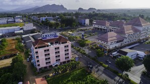 A hotel with a prominent sign, multiple floors, and a parking area. - Crystal Hotel Krabi (Krabi)