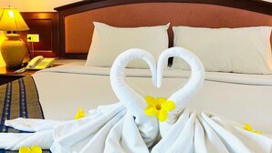A hotel room with a neatly made bed, a telephone, and a lamp on a bedside table. - Crystal Hotel Krabi (Krabi)