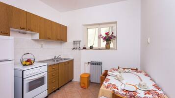 Apartment (One-Bedroom Apartment with Sea View) | Private kitchen | Fridge