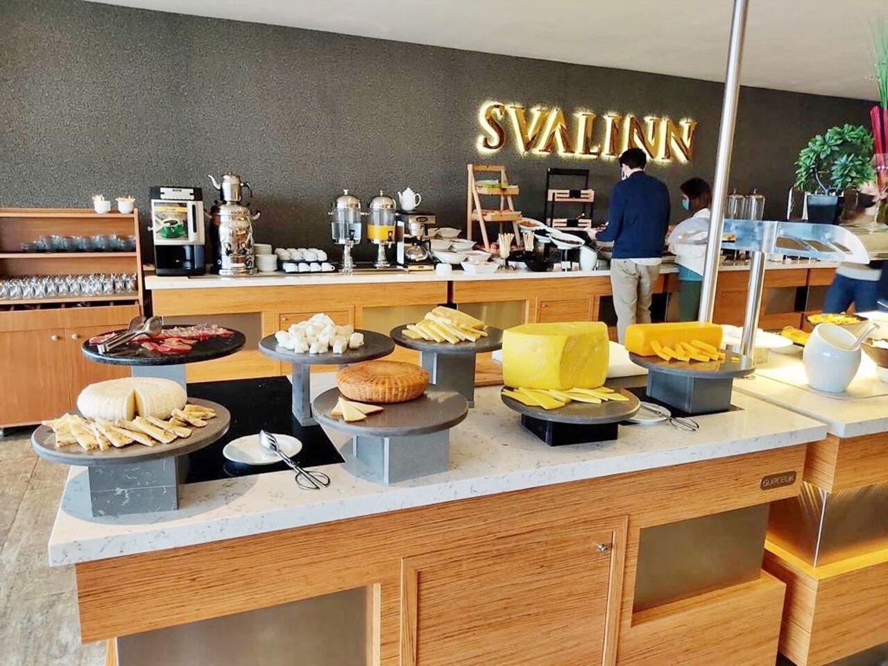 A buffet area with various food items and a coffee station.