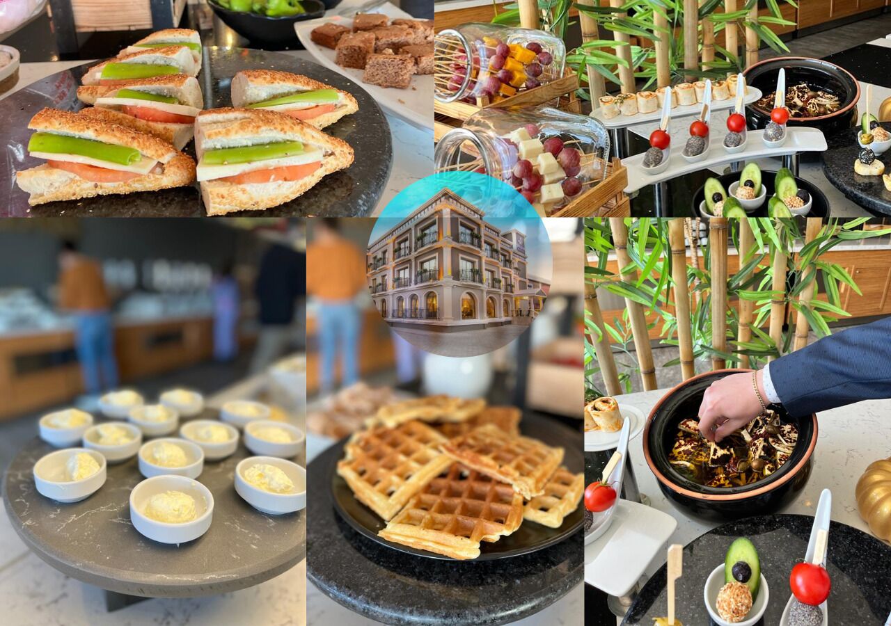 A variety of food items including sandwiches, desserts, and waffles, displayed on a counter in a restaurant setting.