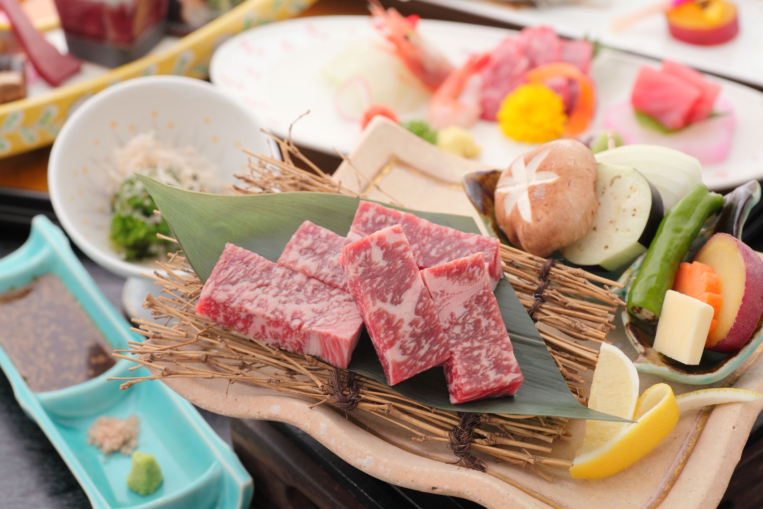 A variety of food items including sliced meat, vegetables, and fruits on a table.