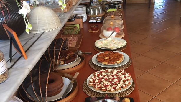 Une table de buffet garnie de divers plats et agrémentée d’un centre de table décoratif.