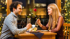 A couple dining at a table with a city view, a rose, and a candle. - The Stable Courtyard Bedrooms at Leeds Castle (Maidstone)