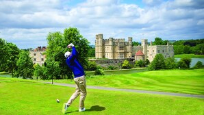 A golf course with a castle in the background. - The Stable Courtyard Bedrooms at Leeds Castle (Maidstone)