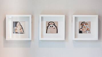 Three framed artworks on a wall.
