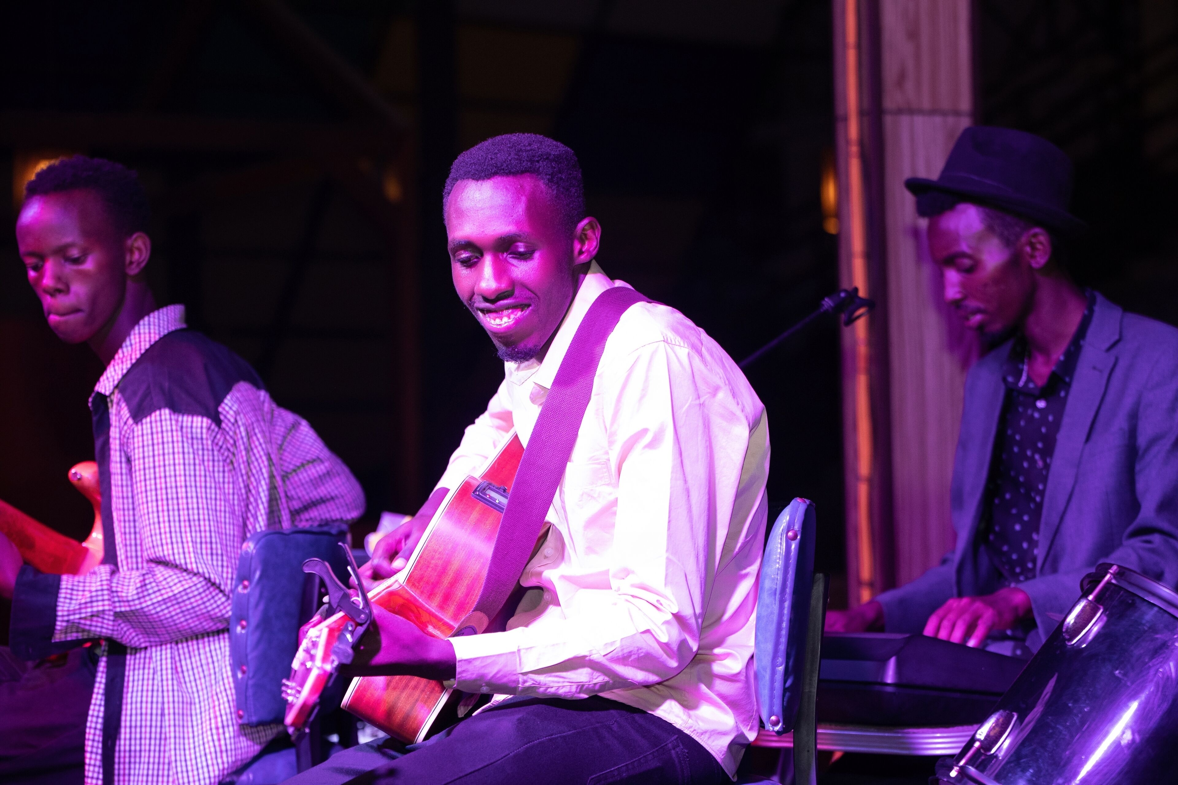 A band performing on stage with musical instruments.