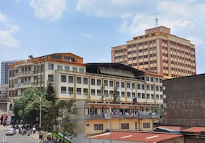 A hotel with multiple floors, balconies, and a prominent '2000' sign on top.