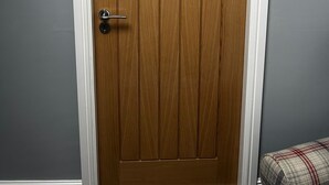 A closed wooden door with a number '1' on it, white trim, and a metal handle. - Chevin End Guest House (Ilkley)
