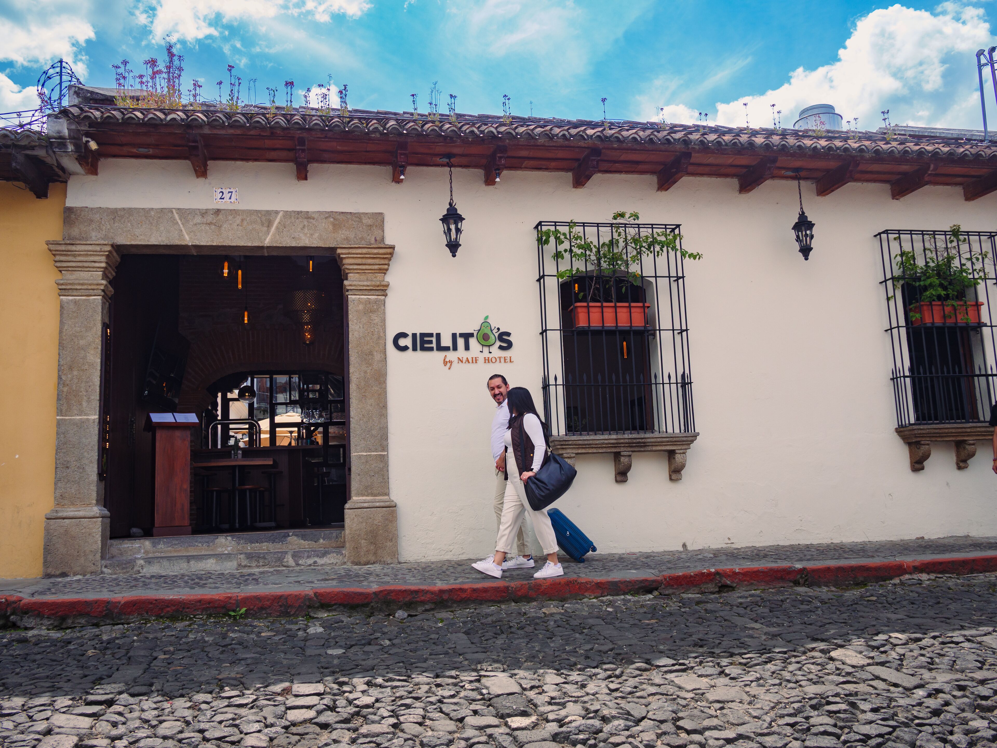 A building with a sign for 'Cielit by NAIF Hotel'.