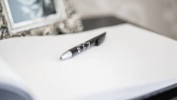 A pen on a white surface with a blurred background.