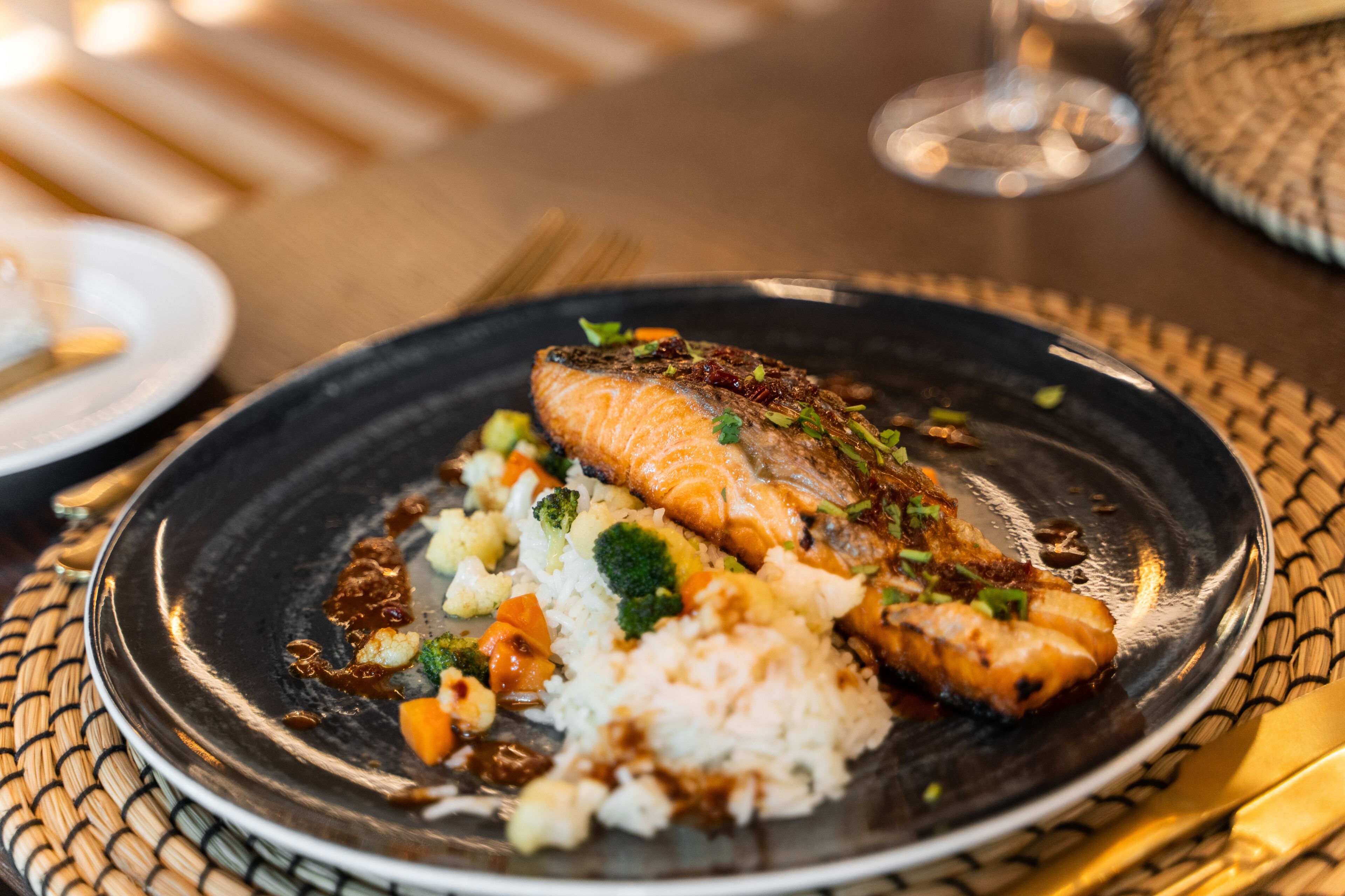 A plate with salmon, rice, and vegetables.