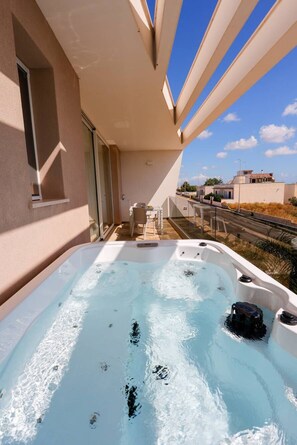 A hot tub on a balcony with a clear view of the street and buildings. - Le Murge del salento (Uggiano la Chiesa)