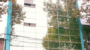 A building with a modern glass facade and a colorful storefront below.