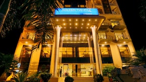 A hotel entrance with a sign reading "Golden Tulip Haridwar."
