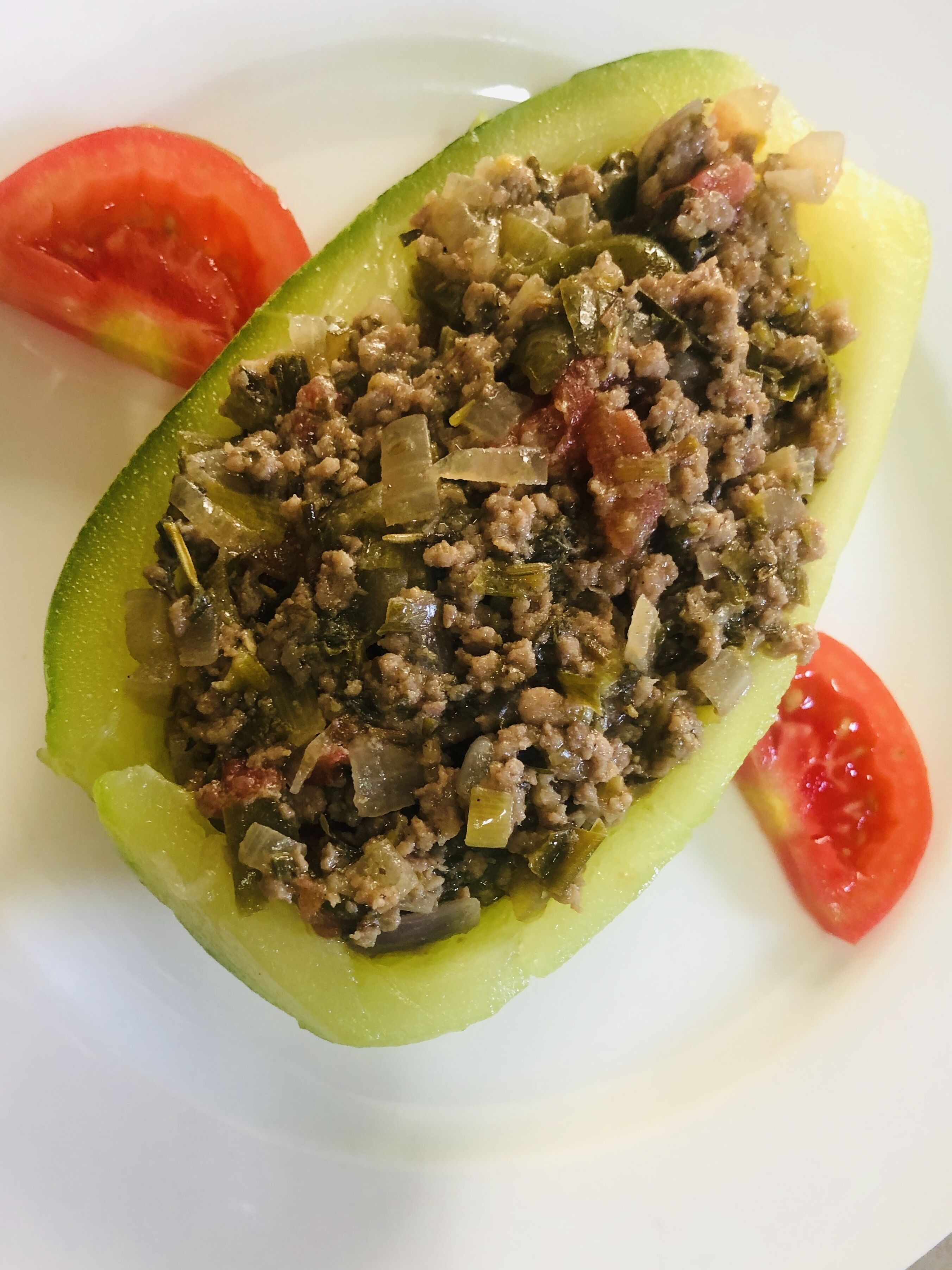 A stuffed bell pepper with a filling of ground meat and vegetables.