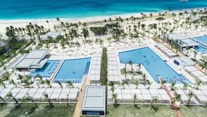 A resort with multiple swimming pools, a beach, and palm trees. - Hotel Riu Republica - Adults only - All Inclusive (Punta Cana)