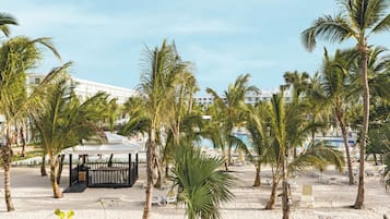 On the beach, white sand, sun-loungers, beach towels