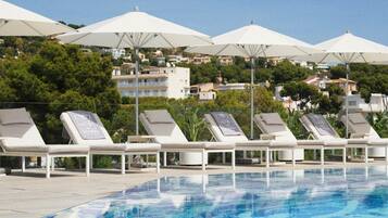 Seasonal outdoor pool, a natural pool, pool umbrellas, pool loungers