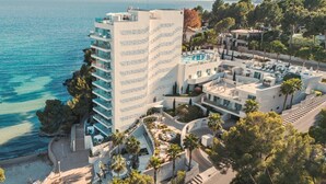 A coastal hotel with multiple floors, balconies, and a pool area. - The Donna Portals (Calvia)