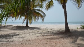 A sandy beach with palm trees and a clear view of the ocean. - Oudja Hotel (Cap Skirring)