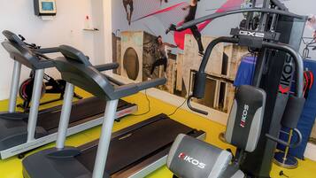 A gym with treadmills, a bench, and a weight machine.