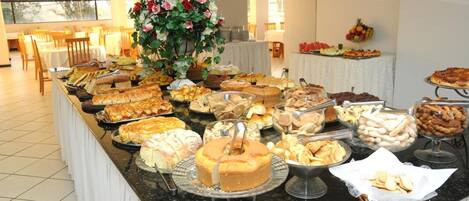 A buffet with various baked goods and pastries.