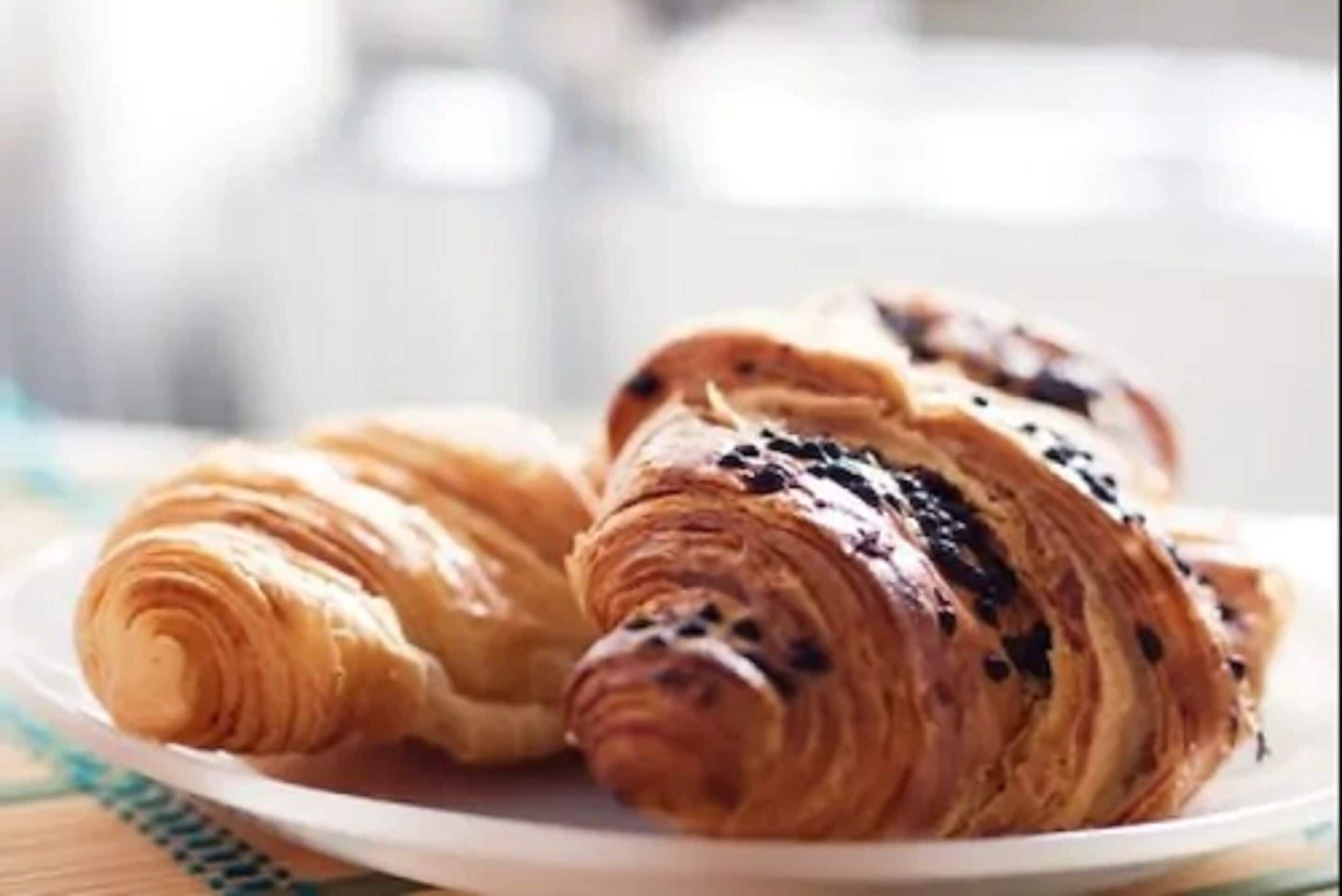 Two croissants on a plate.