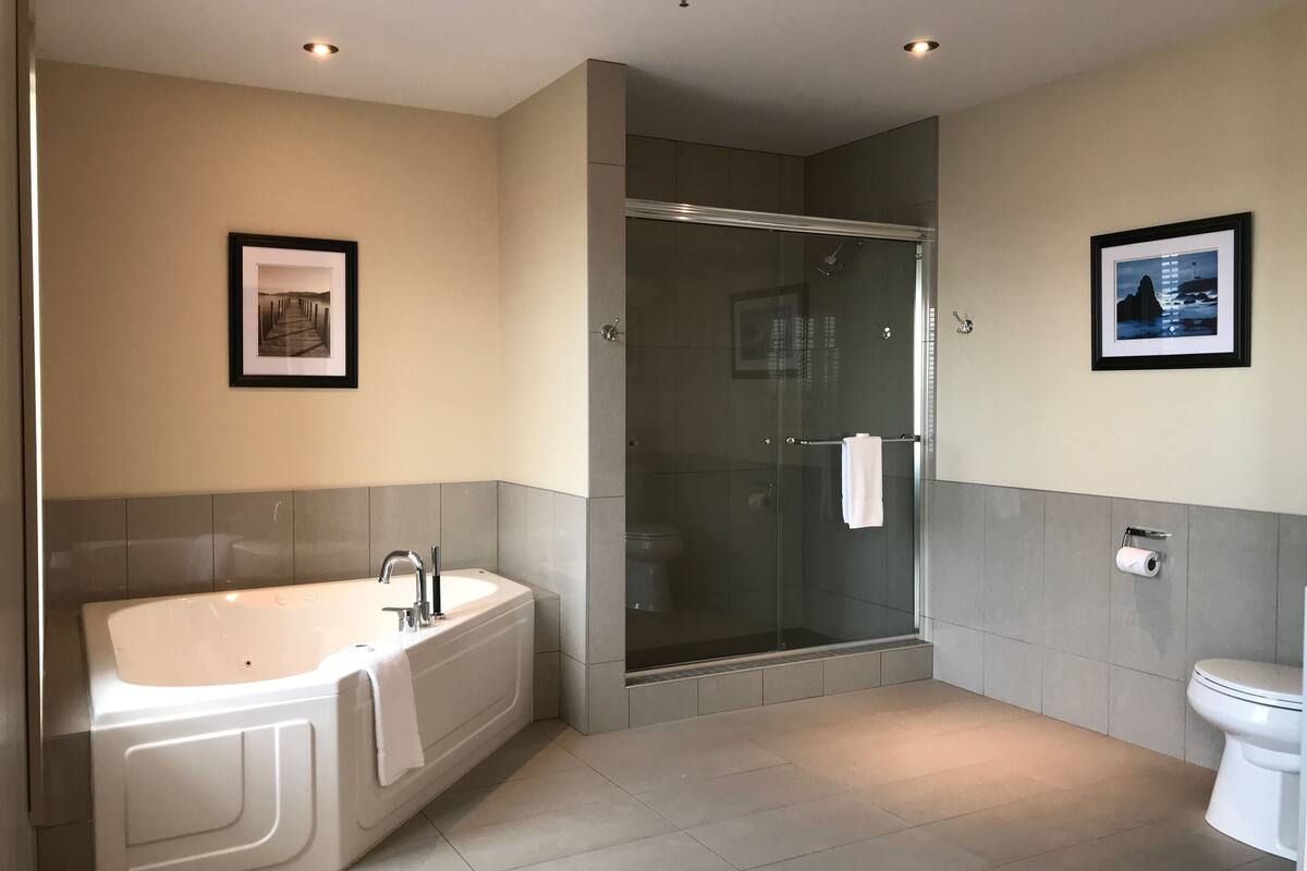 signature suite, hot tub, marina view | bathroom | designer toiletries, hair dryer, towels, soap